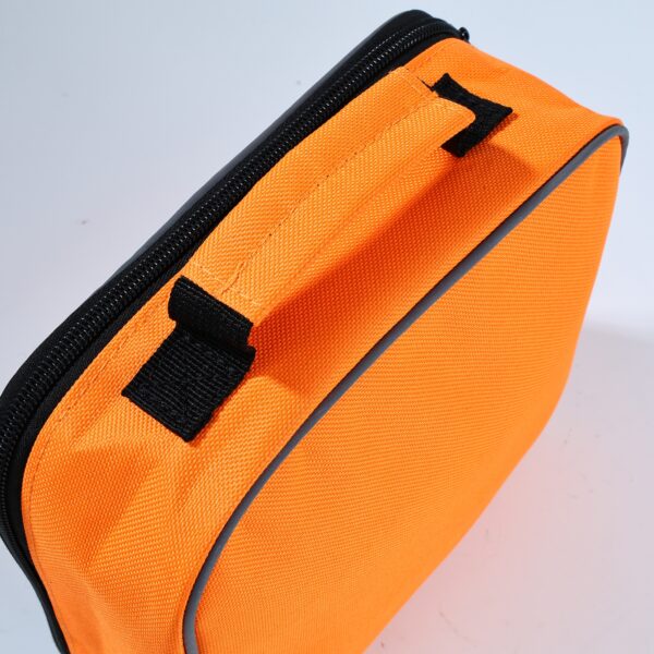 A vibrant orange and black pet first aid bag, essential for pet emergencies, shown prominently in the image.